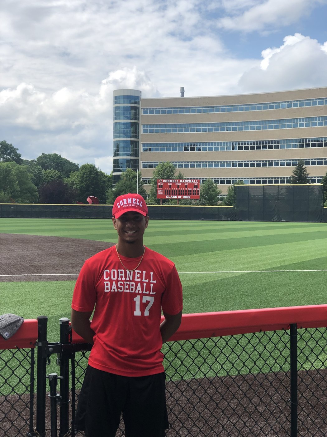 Jakobi in a Cornell Baseball shirt at the Cornell baseball field during Catalyst Academy